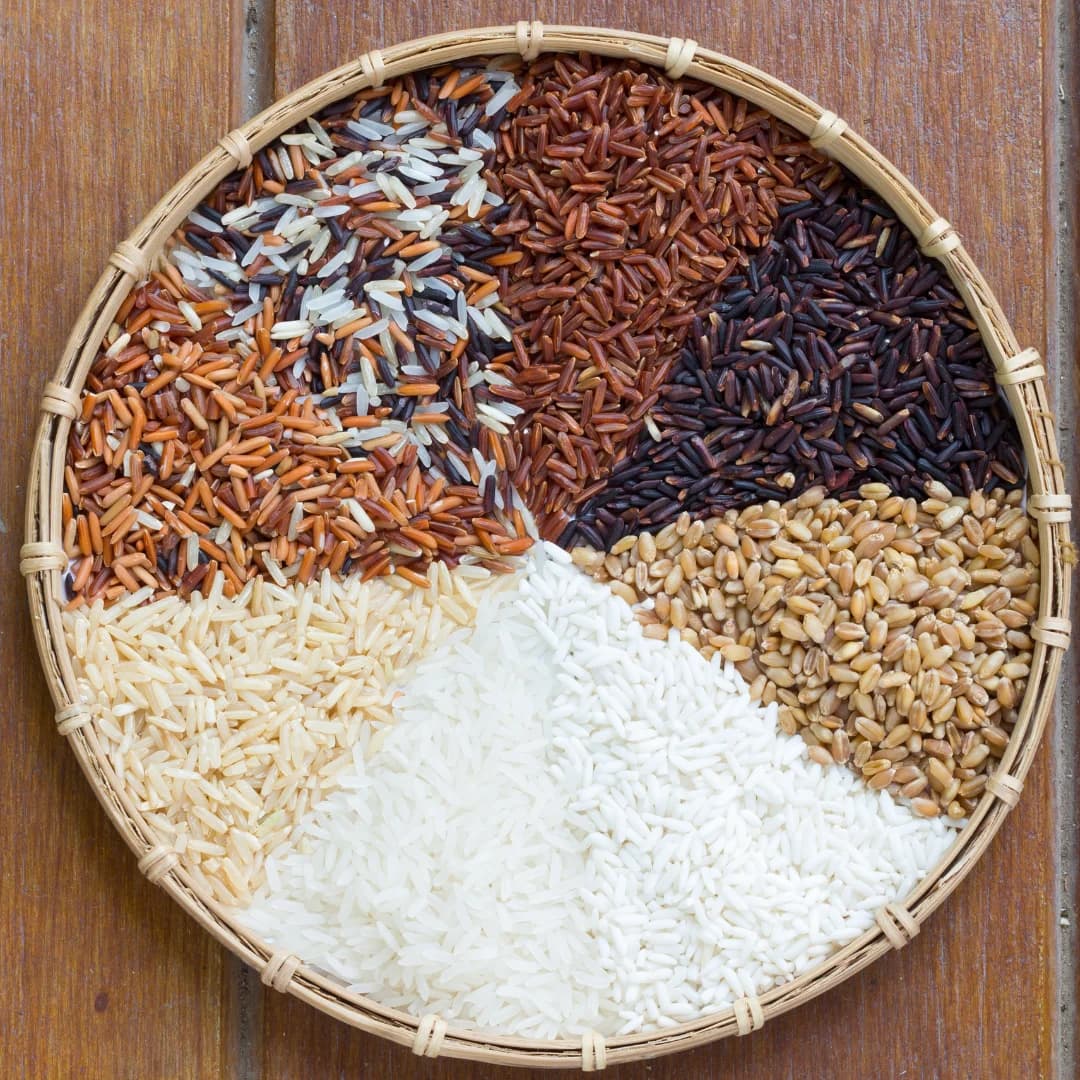 front view all types of rices in the wooden bucket place on wooden table