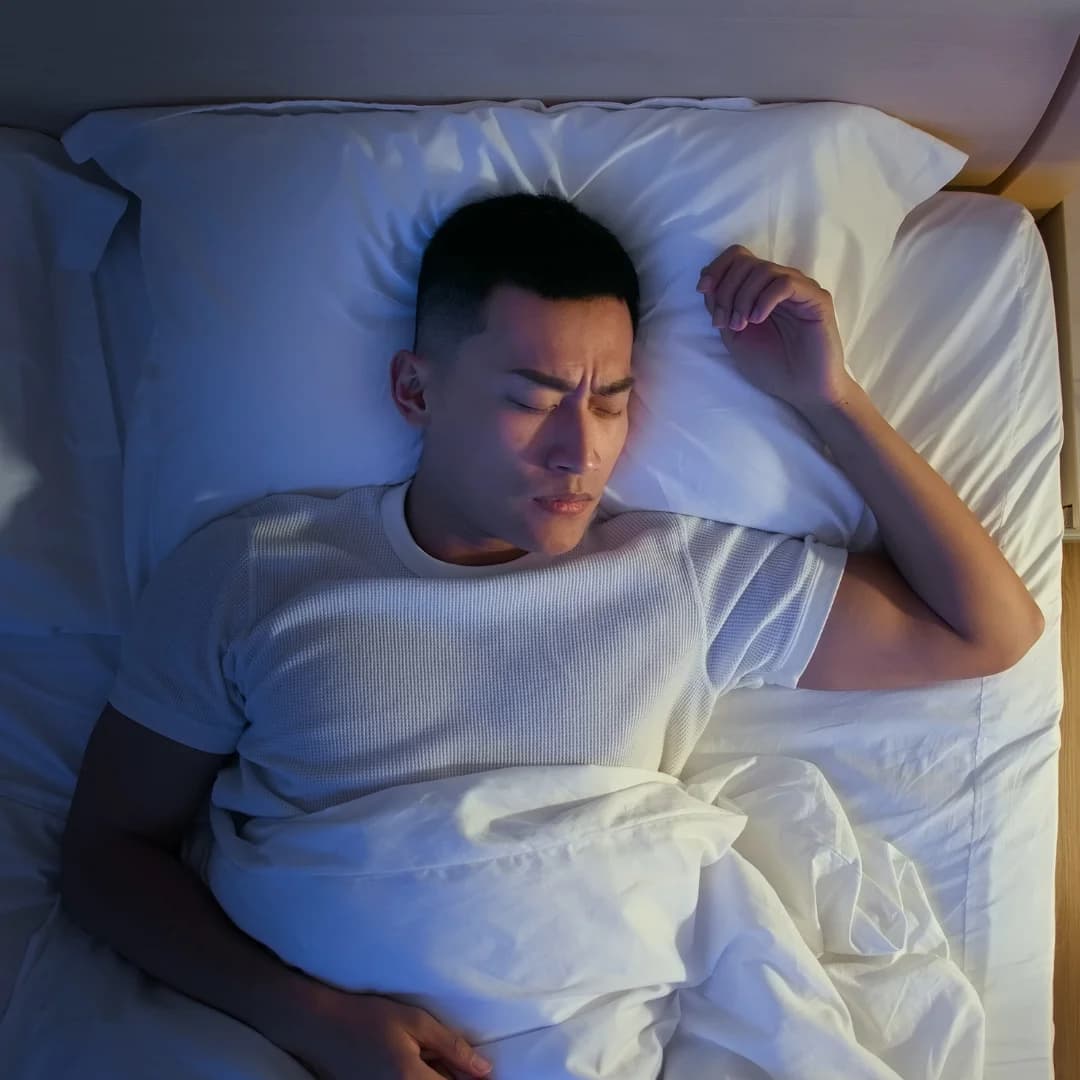 top view of bed where man sleeping peacefully in the night