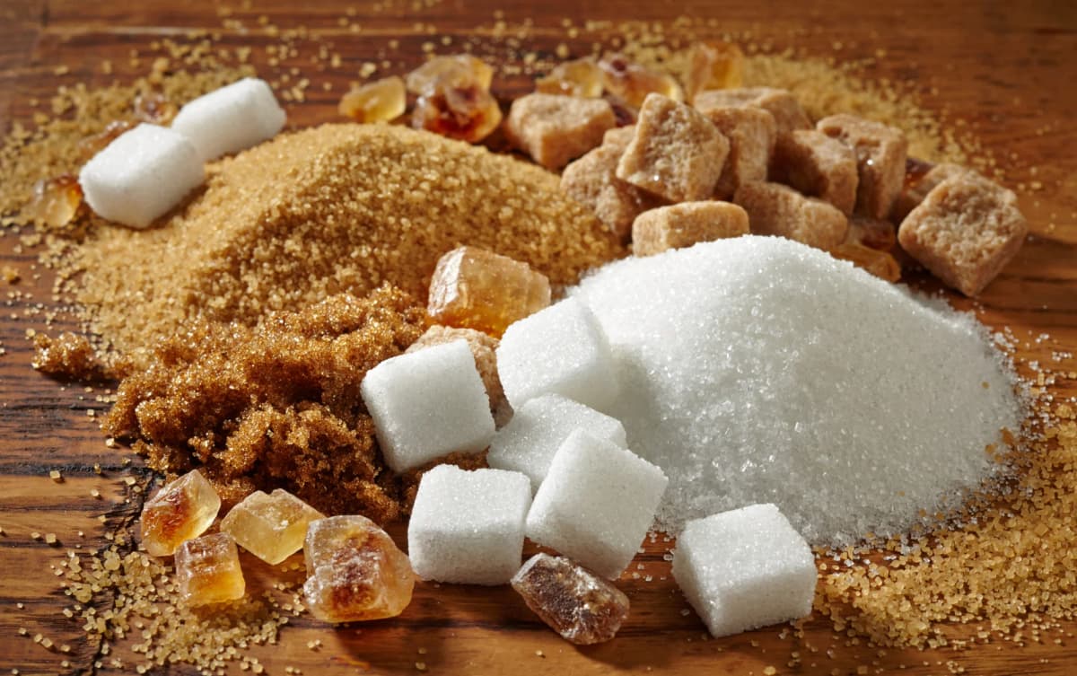 top view of all types of sugars brown sugar, refined sugar etc place separately in the table