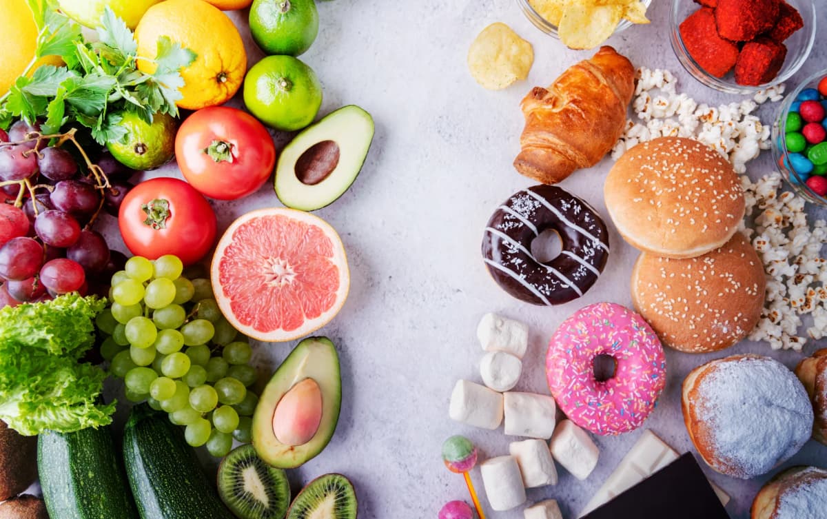 Comparison of healthy and unhealthy foods fresh fruits and vegetables on the left, and processed sweets, donuts and fast food