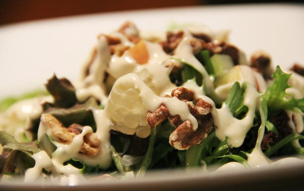 Micro zoomed view of fresh salad topped with creamy mayonnaise