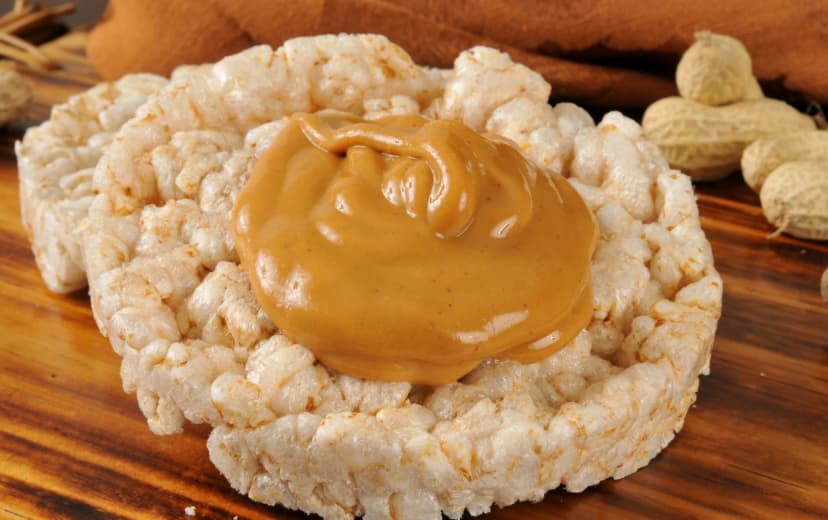 Rice cake topped with a thin layer of peanut butter