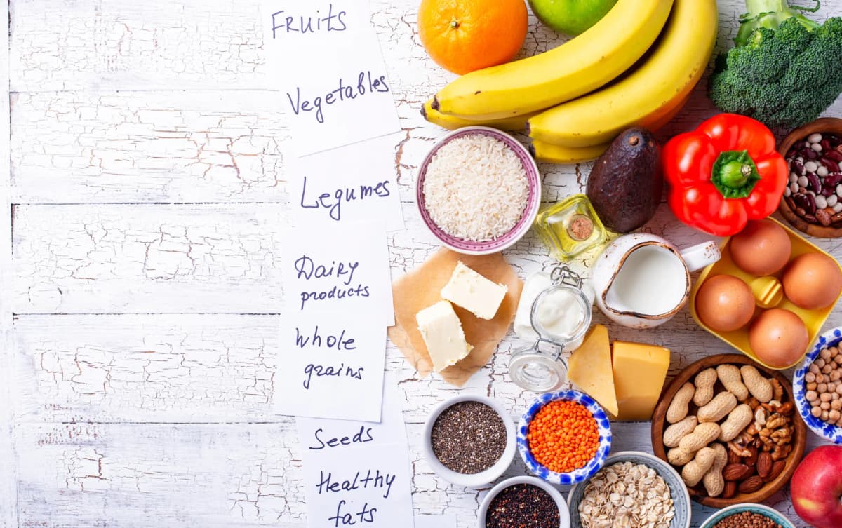 top view lots of healthy things on the table eggs bananas nuts vegetables and more