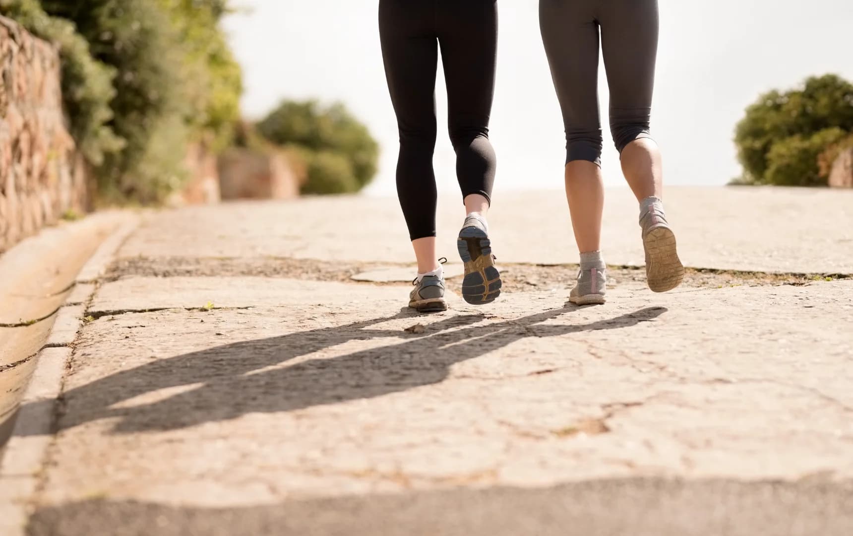 Bottom view of men and women doing morning walk outdoors for fitness and health